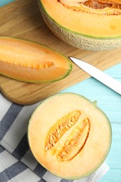 Photo of Tasty fresh melons on light blue wooden table, flat lay