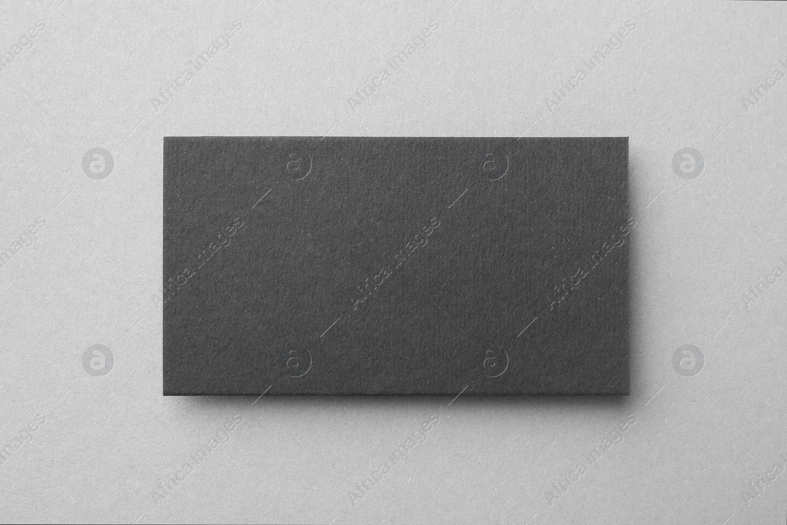 Photo of Blank black business card on light background, top view. Mockup for design