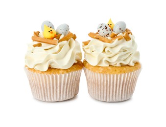 Photo of Tasty Easter cupcakes with vanilla cream isolated on white