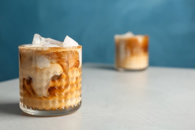 Photo of Glass with cold brew coffee and milk on table