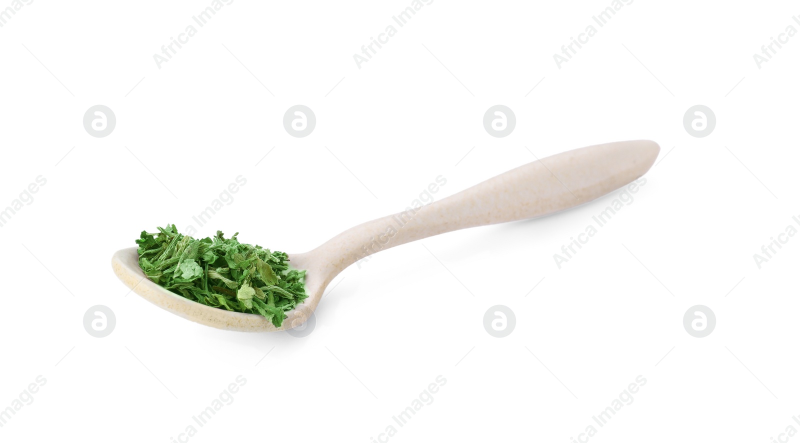 Photo of Spoon of dried parsley isolated on white