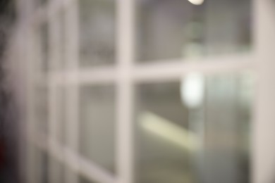 Photo of Blurred view of empty corridor with glass door in company