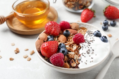 Photo of Tasty homemade granola served on table. Healthy breakfast