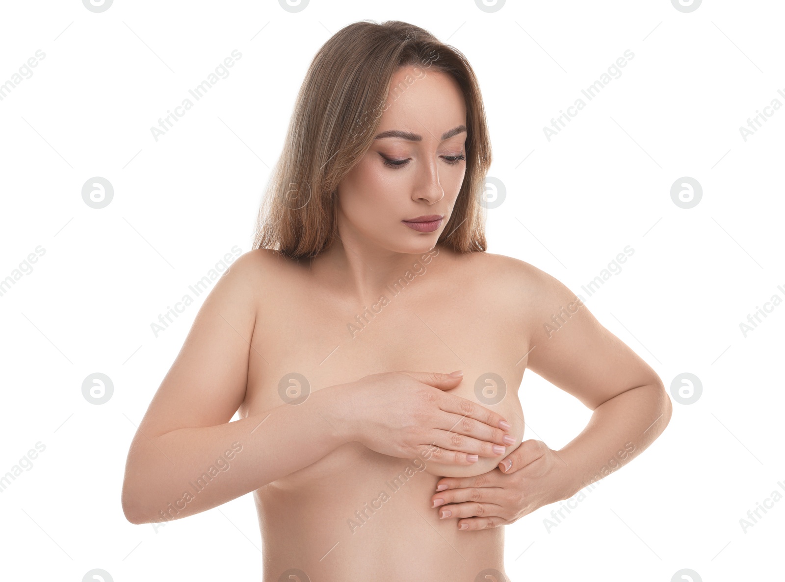 Photo of Mammology. Naked young woman doing breast self-examination on white background