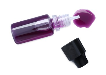 Photo of Bottle of purple food coloring on white background, top view