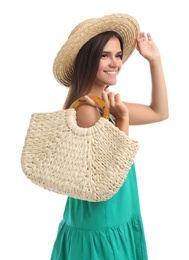 Young woman with stylish straw bag on white background