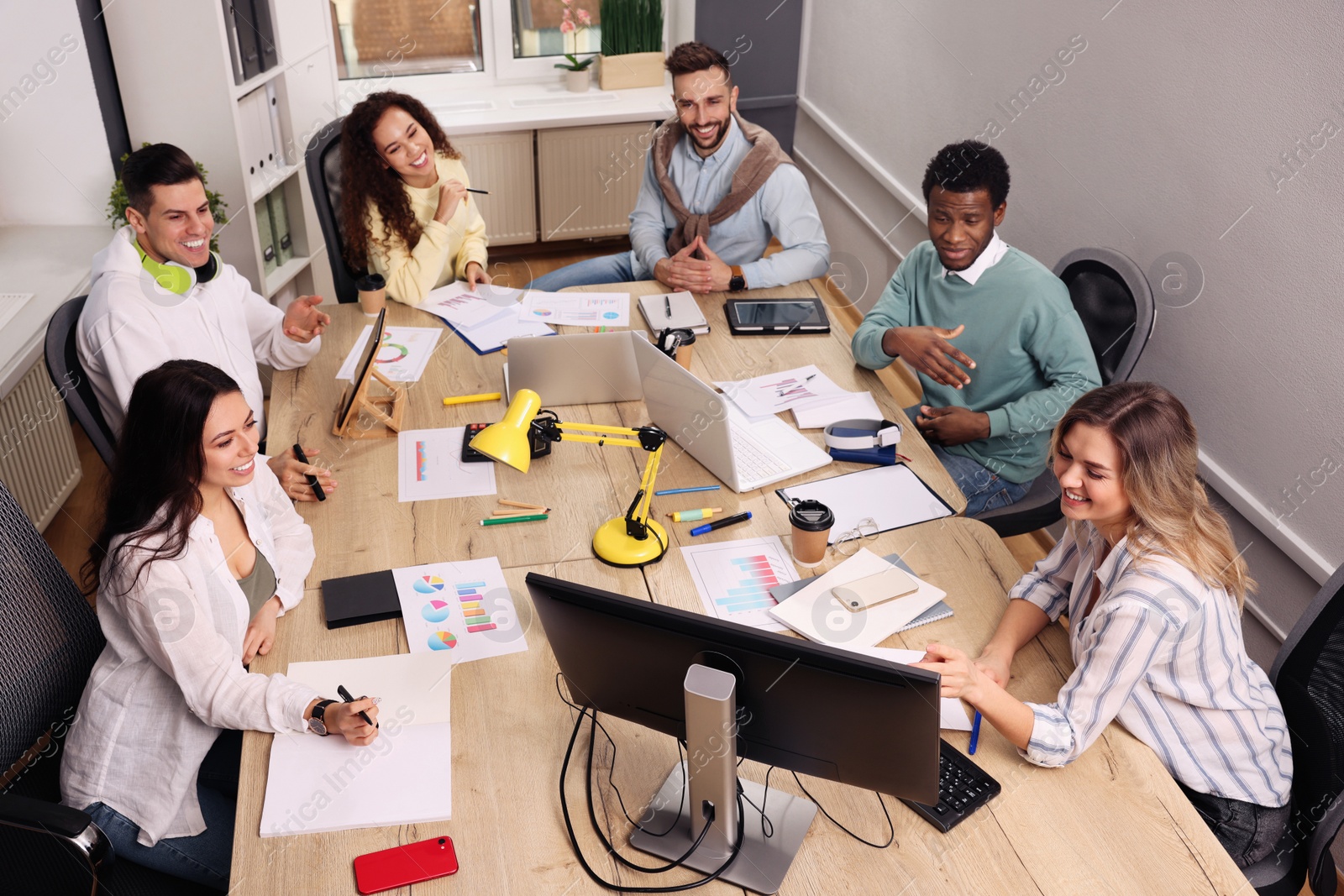 Photo of Team of employees working together in office. Startup project