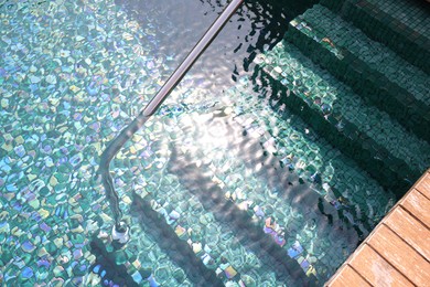 Photo of Outdoor swimming pool with steps and rail at resort