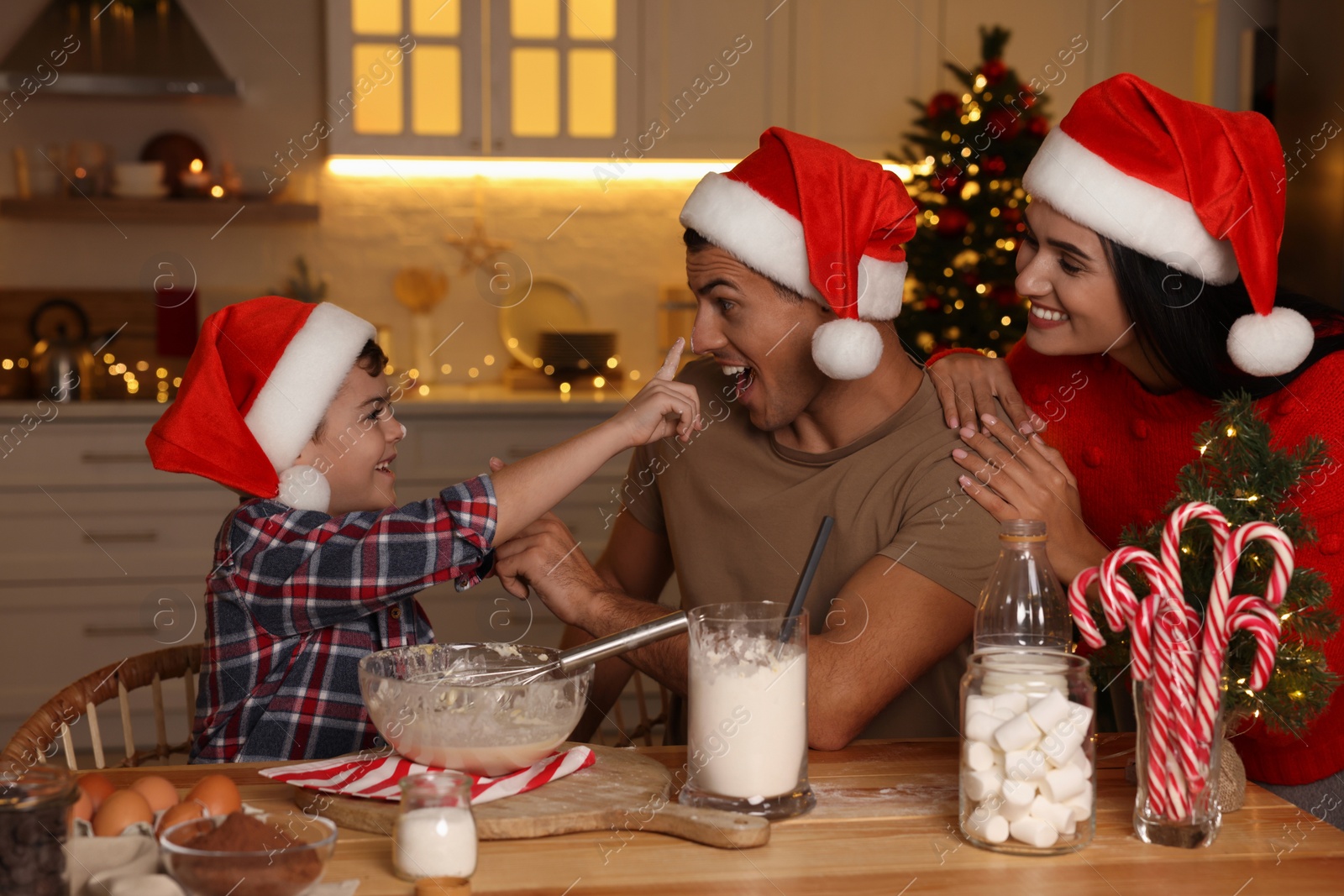 Photo of Happy family making dough for Christmas cookies at home