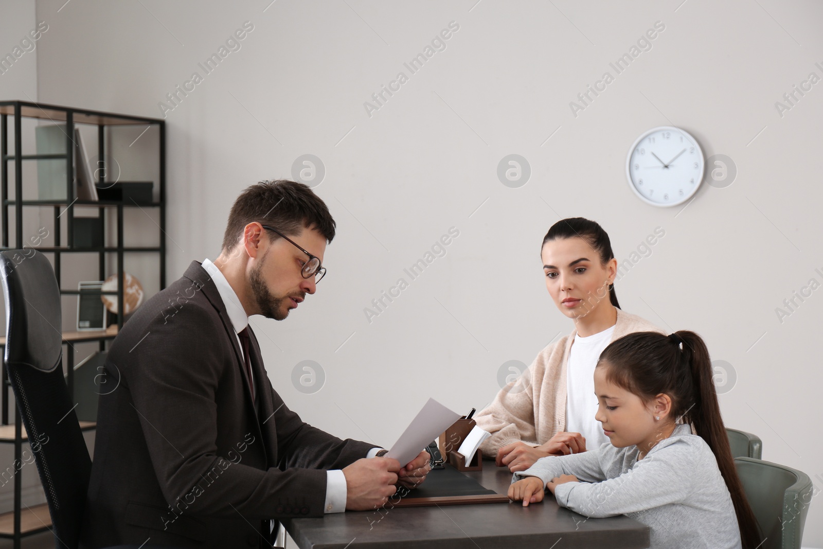 Photo of Mother and daughter having meeting with principal at school