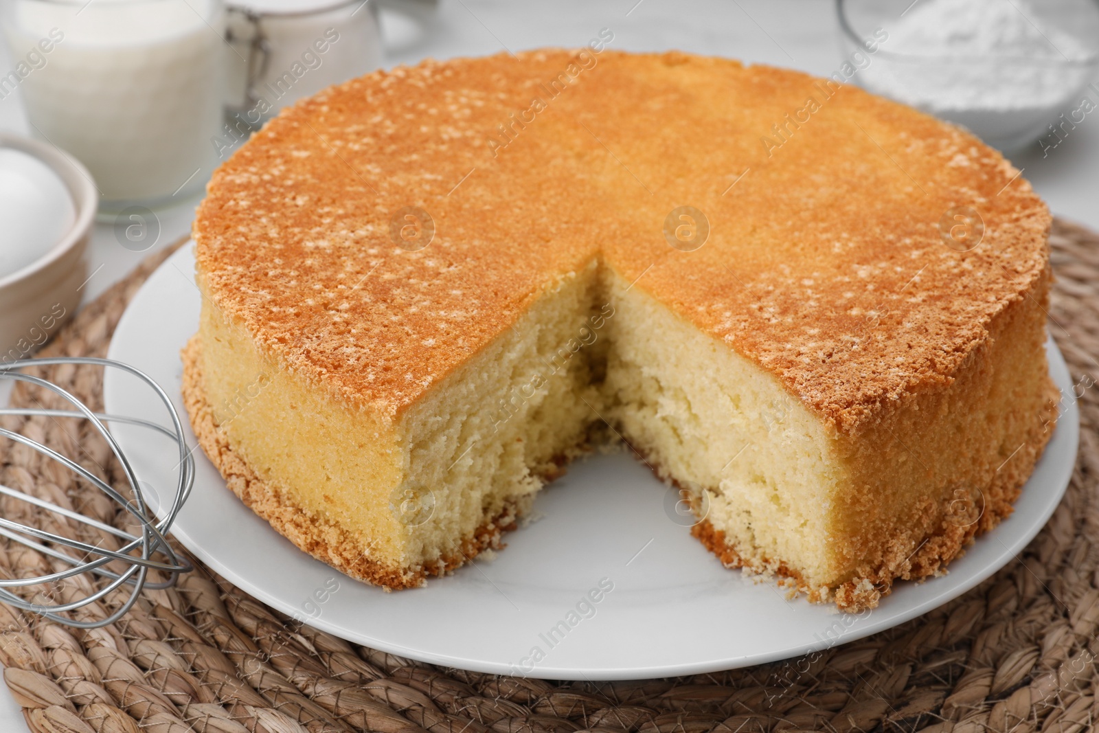 Photo of Cut tasty sponge cake on table, closeup