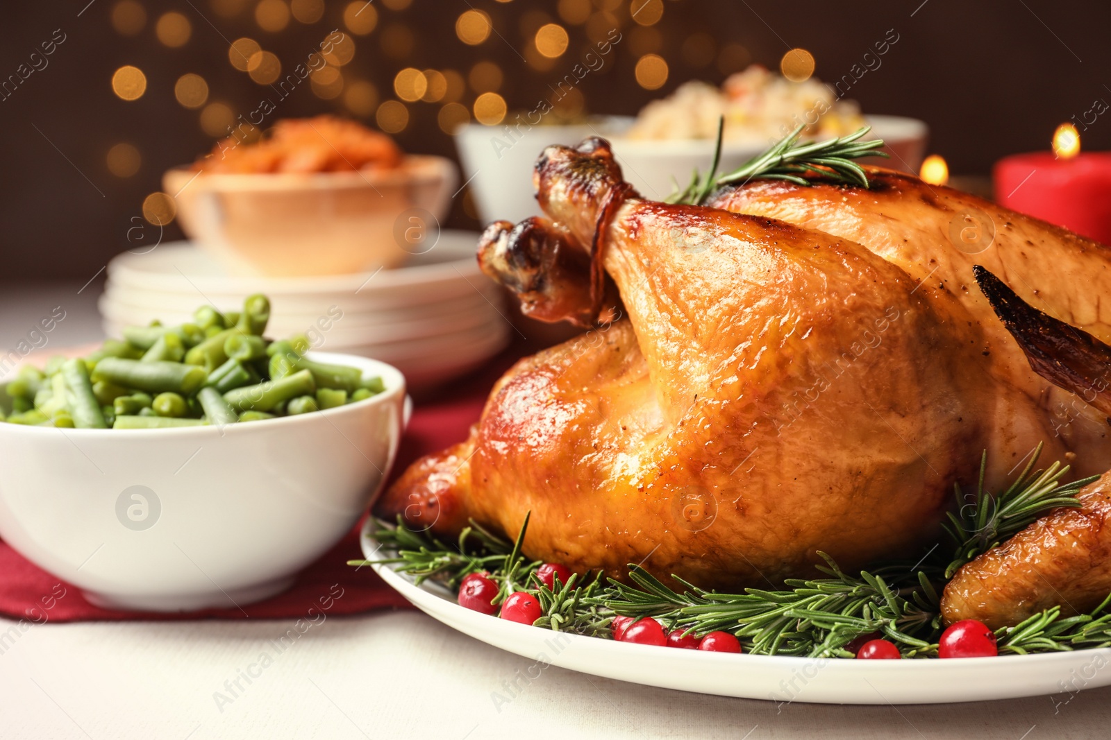 Photo of Delicious roasted turkey on festive table, closeup