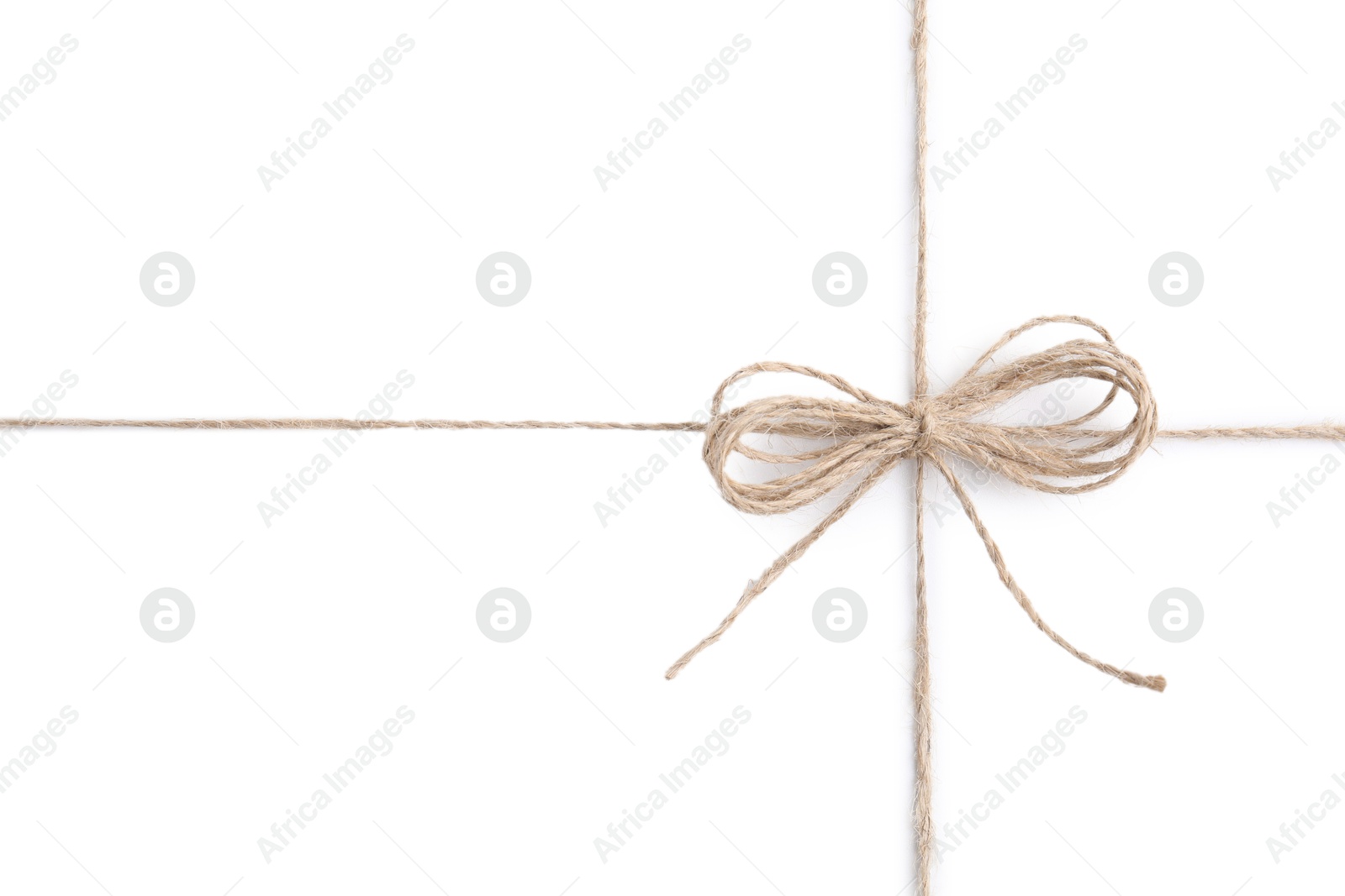 Photo of Linen rope string with bow isolated on white, top view