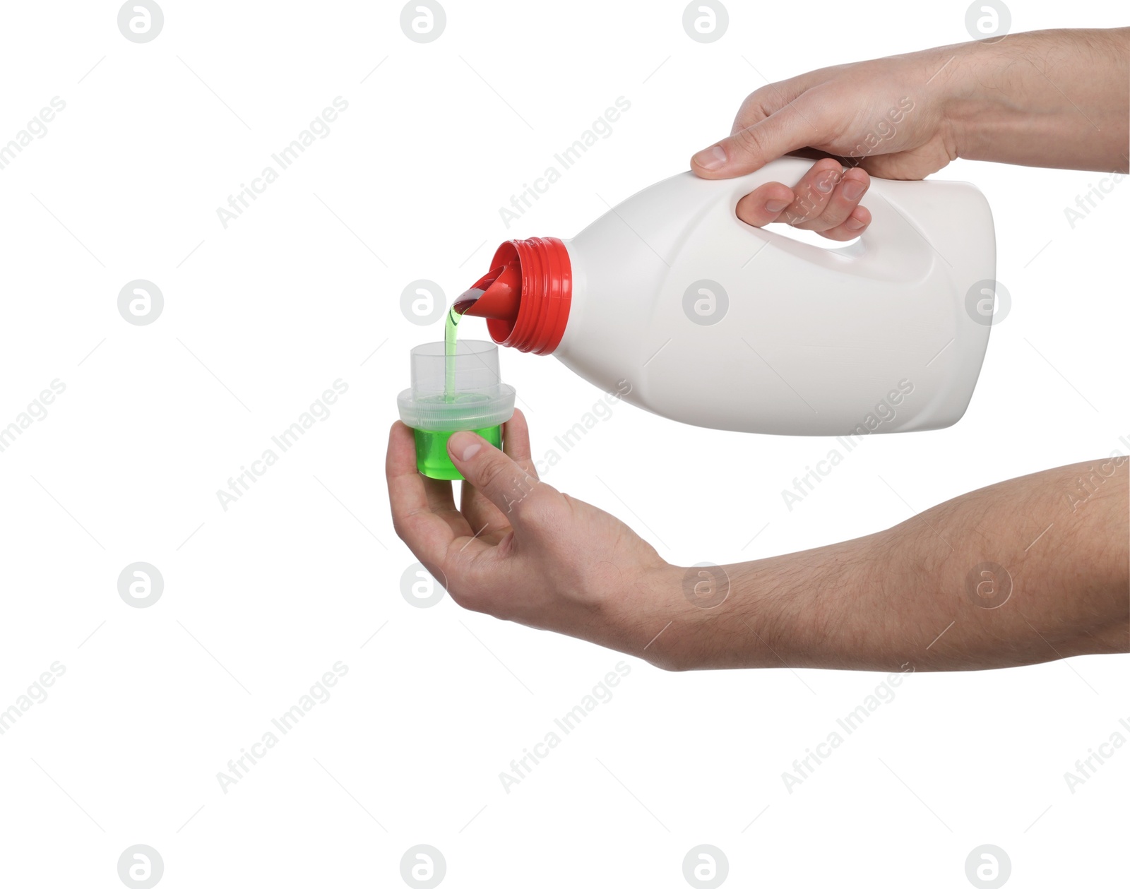 Photo of Man pouring fabric softener from bottle into cap for washing clothes on white background, closeup