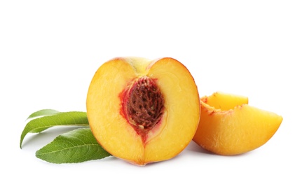 Photo of Cut fresh ripe peach with leaves on white background