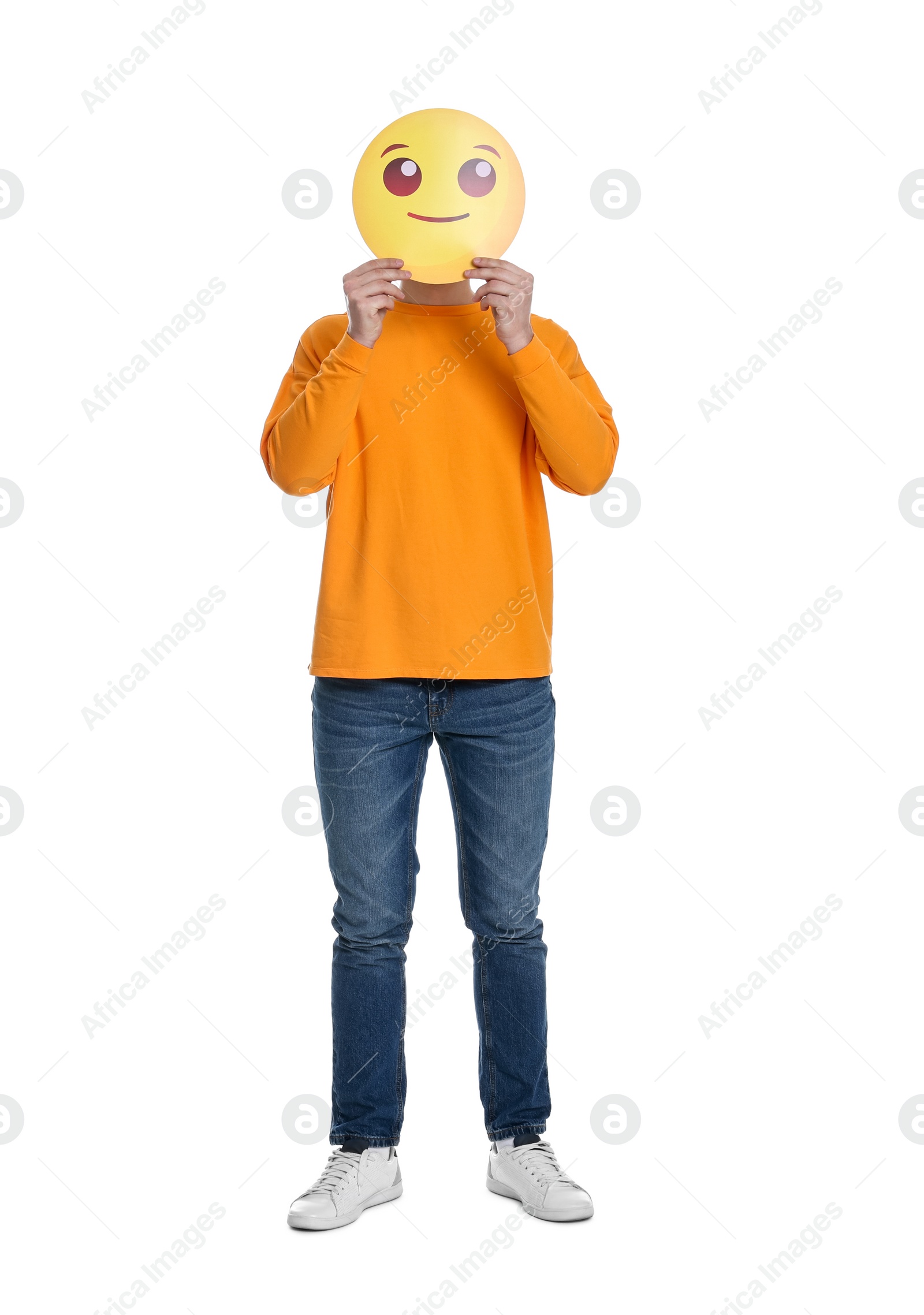 Photo of Man covering face with smiling emoticon on white background