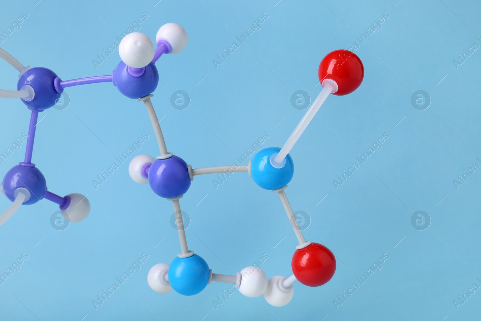 Photo of Molecule of phenylalanine on light blue background, closeup. Chemical model