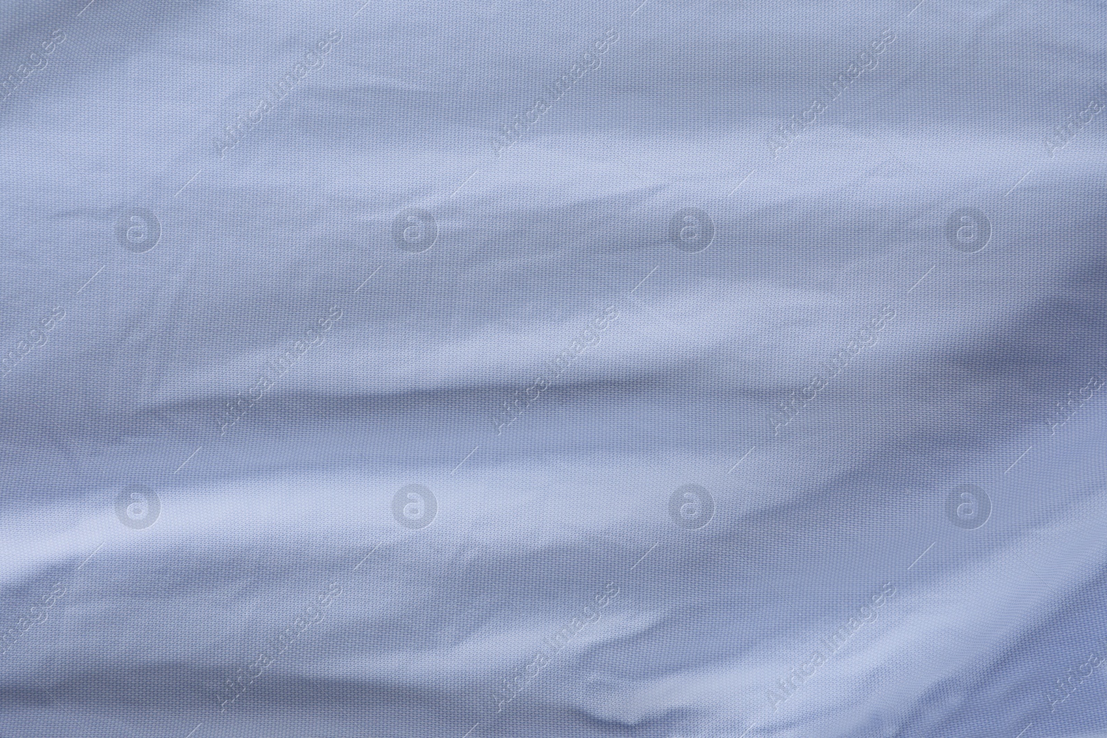 Photo of Crumpled light blue fabric as background, top view