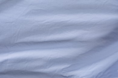 Crumpled light blue fabric as background, top view