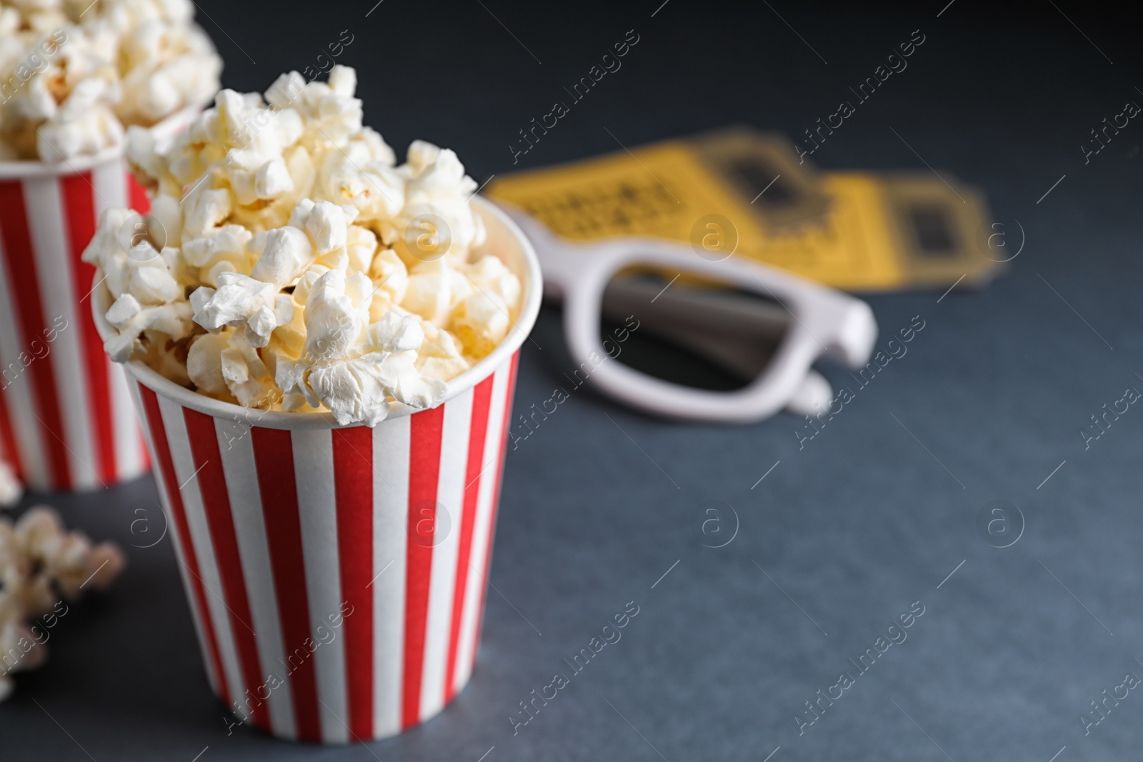 Photo of 3D glasses, popcorn and cinema tickets on table. Space for text