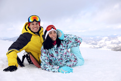 Lovely couple on snowy hill. Winter vacation