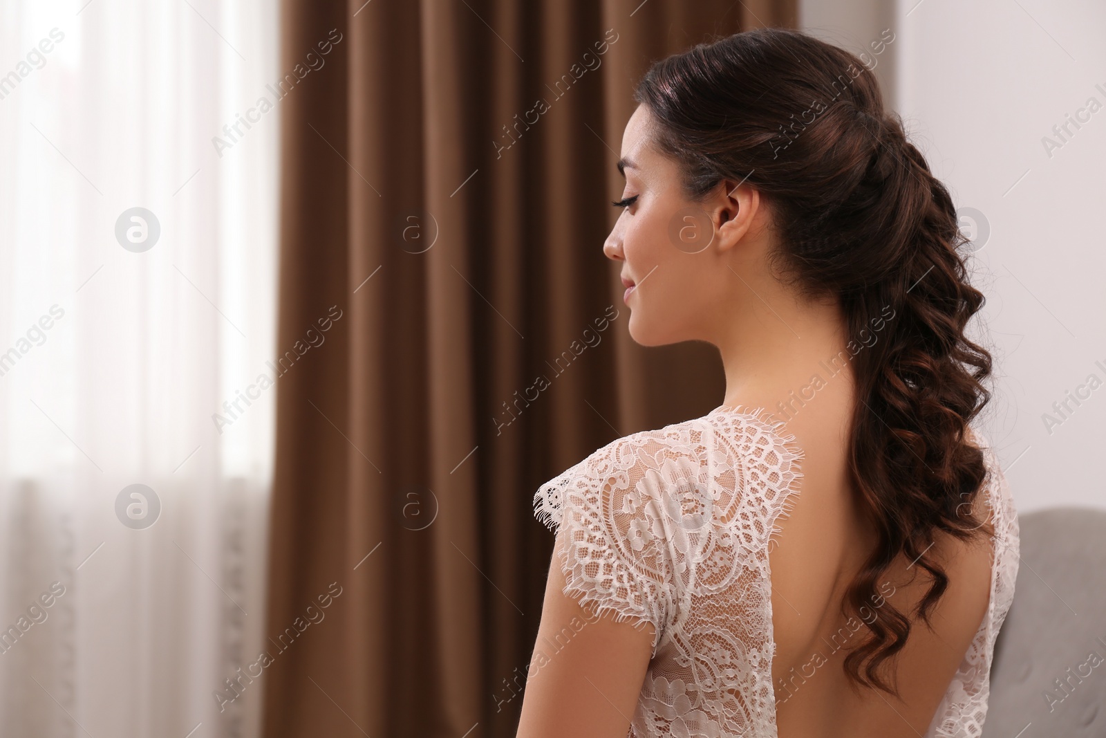 Photo of Young woman with beautiful hairstyle indoors. Space for text