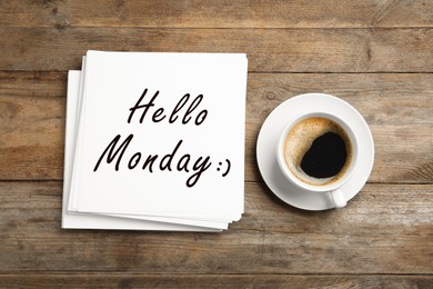 Image of Start your week with good mood. Paper sheets with text Hello Monday and cup of coffee on wooden table, flat lay