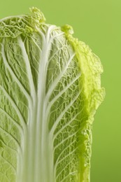 Photo of Fresh ripe Chinese cabbage on light green background, closeup