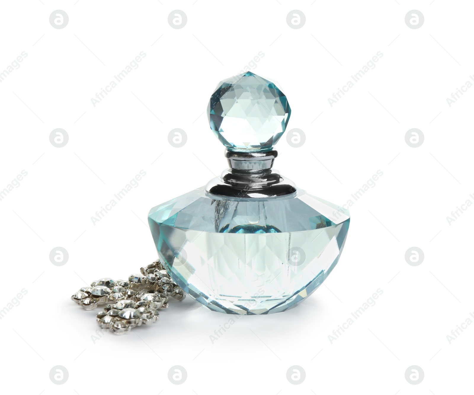 Photo of Glass bottle of perfume and luxury jewellery isolated on white