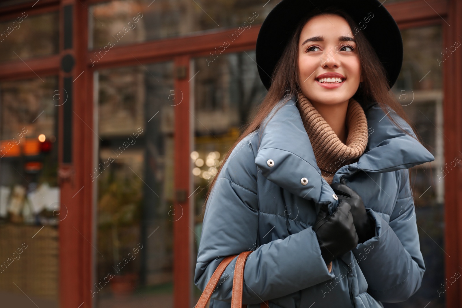 Photo of Young woman wearing stylish clothes outdoors, space for text. Autumn look
