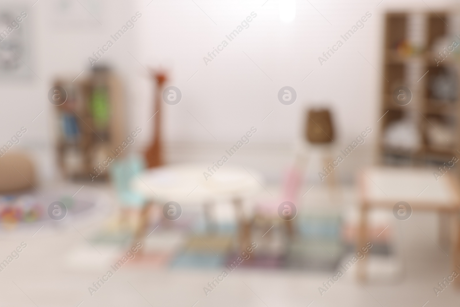 Photo of Stylish kindergarten interior with toys and modern furniture, blurred view