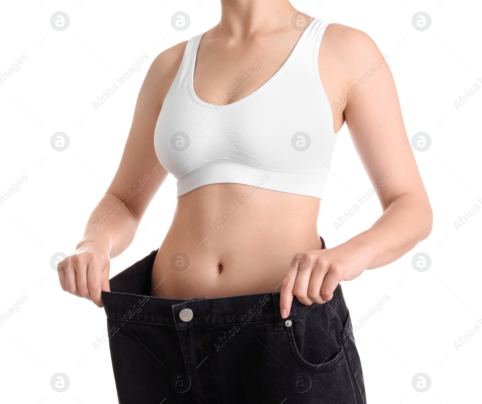 Photo of Young slim woman wearing oversized jeans on white background, closeup