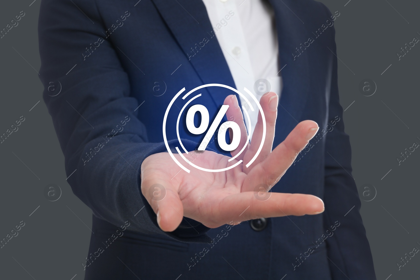 Image of Man showing virtual percent sign on grey background, closeup. Discount concept