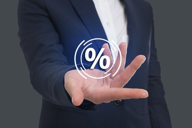 Man showing virtual percent sign on grey background, closeup. Discount concept