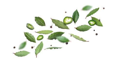 Image of Bay leaves, black and fresh green peppers flying on white background