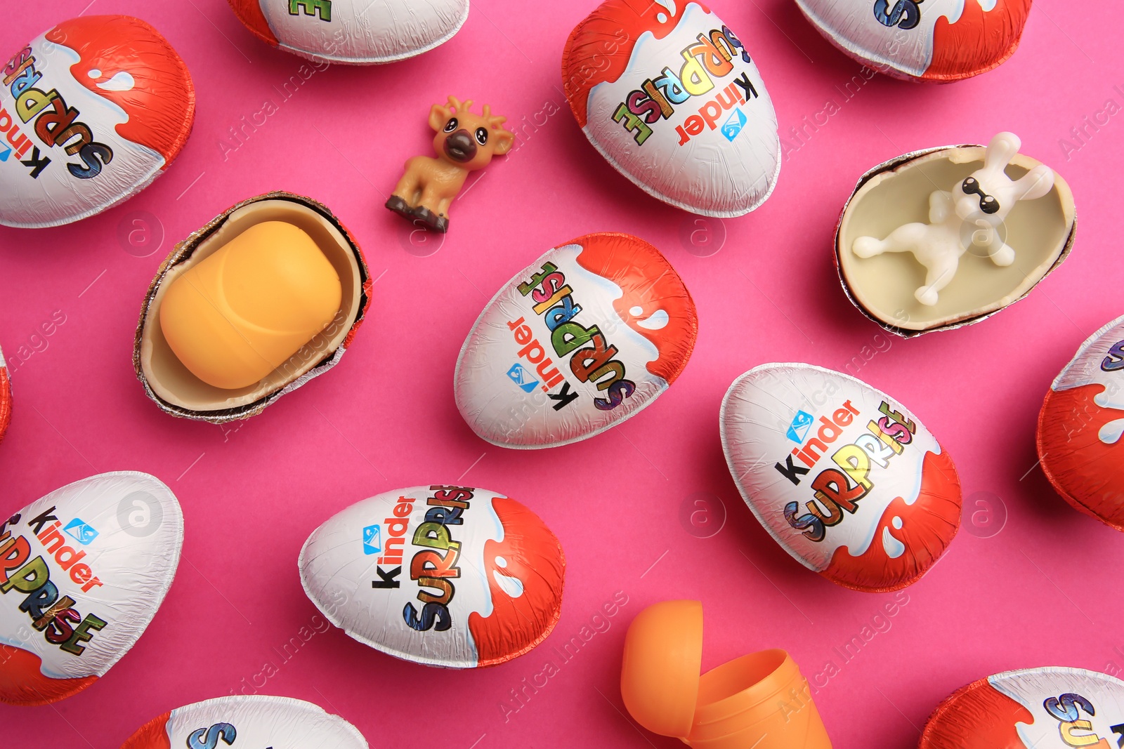 Photo of Sveti Vlas, Bulgaria - June 26, 2023: Kinder Surprise Eggs, plastic containers and toys on pink background, flat lay