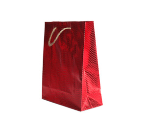 Photo of Red paper shopping bag isolated on white. Space for design