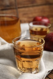 Photo of Glass of delicious apple cider on table. Space for text