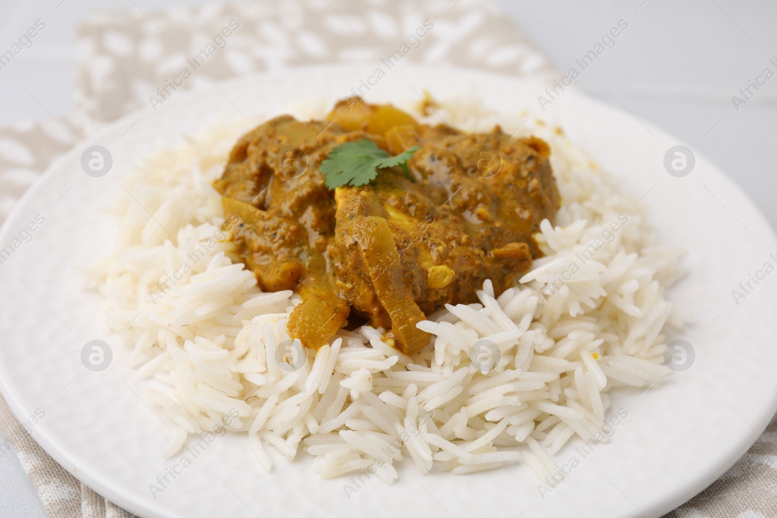 Photo of Delicious chicken curry with rice on table, closeup