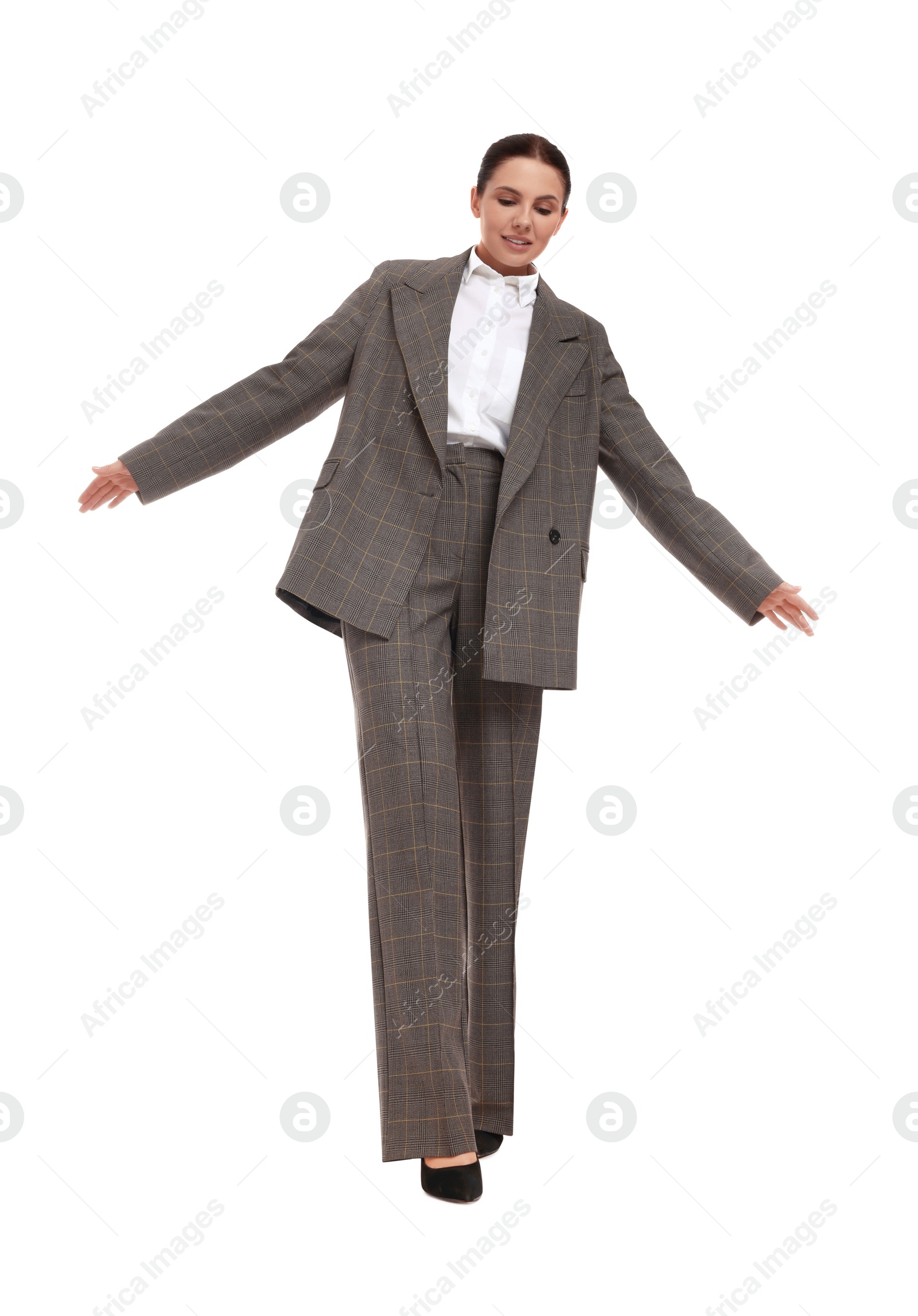 Photo of Beautiful businesswoman in suit walking on white background