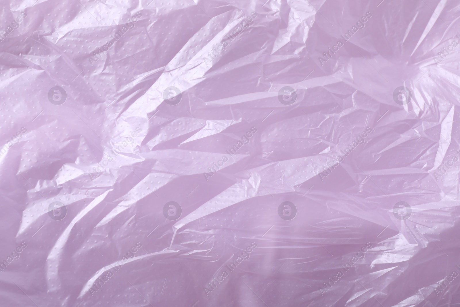 Photo of Texture of violet plastic bag as background, closeup