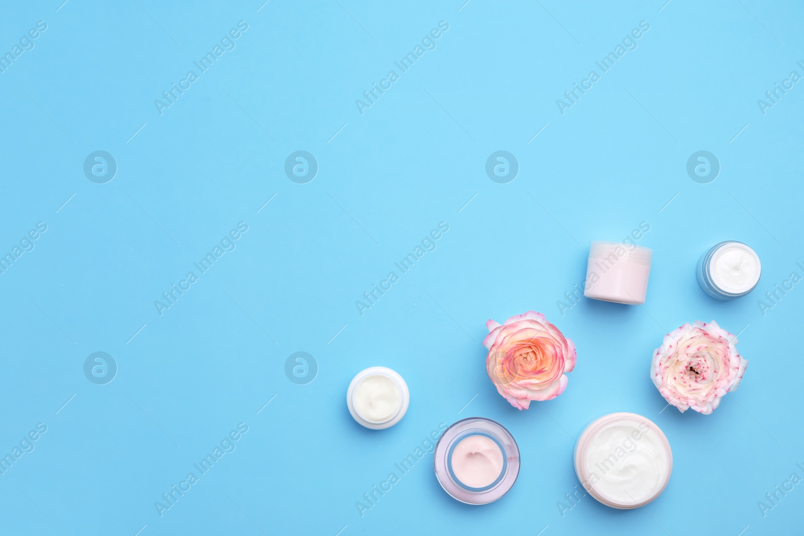 Photo of Flat lay composition with cosmetic products on color background