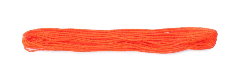 Bright coral embroidery thread on white background