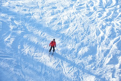 Photo of Male skier on slope at resort. Winter vacation