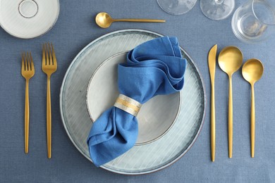 Stylish setting with cutlery, plates, napkin and glasses on table, flat lay