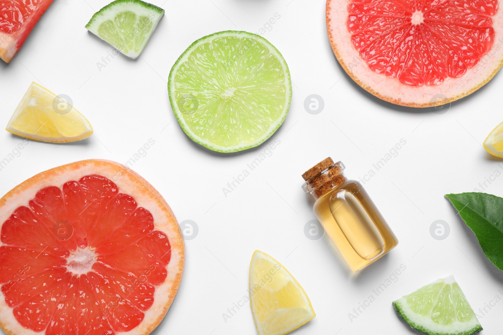 Photo of Flat lay composition with bottle of citrus essential oil on white background