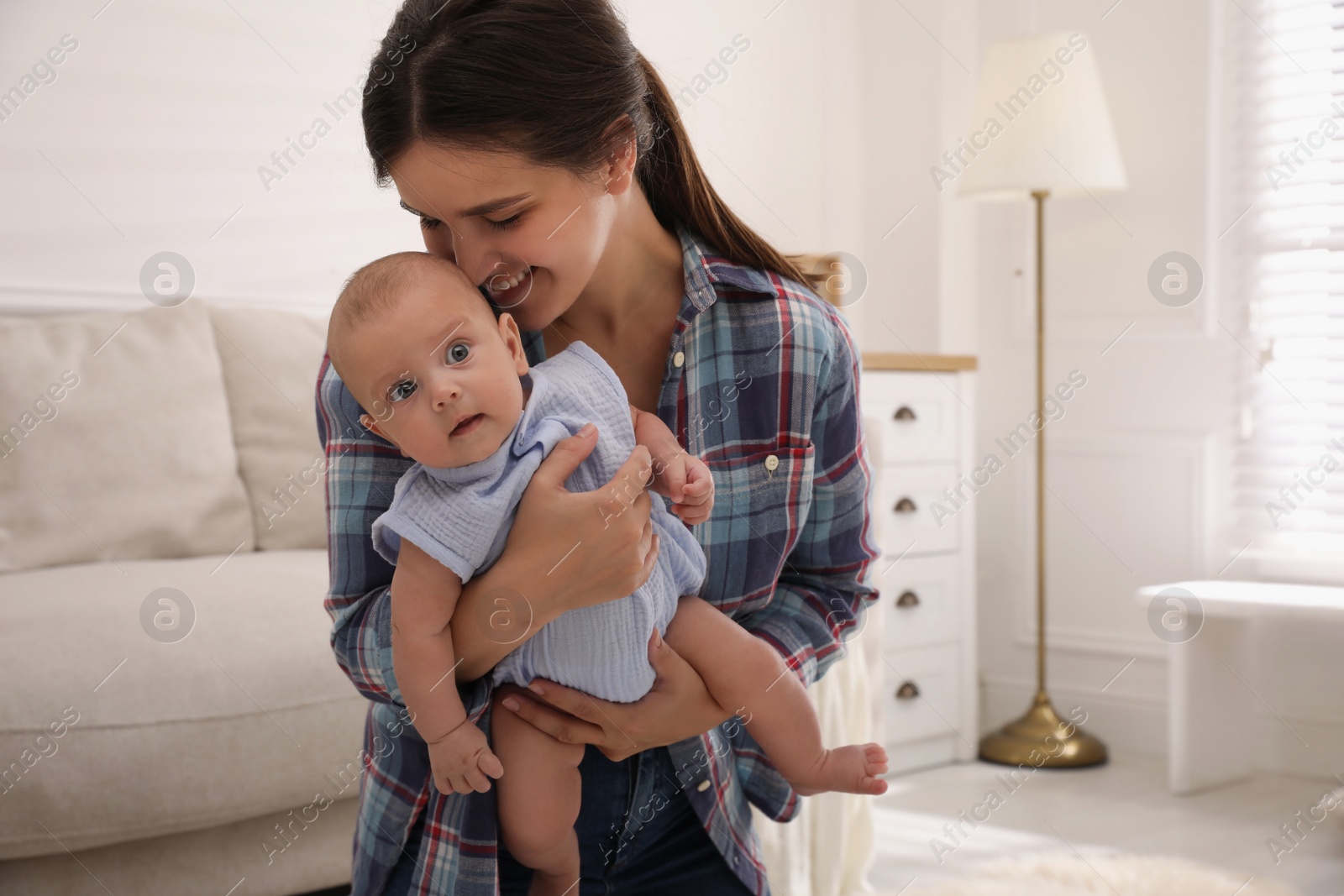 Photo of Happy young mother with her cute baby at home