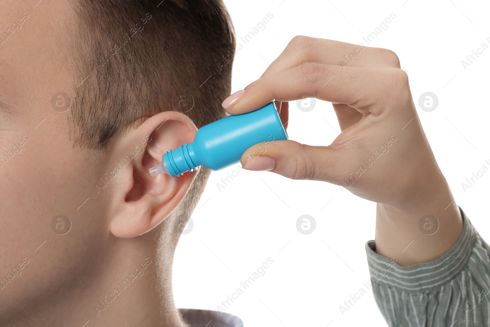Photo of Woman dripping medication into man's ear on white background, closeup