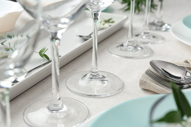 Photo of Elegant glasses on table, closeup. Festive setting