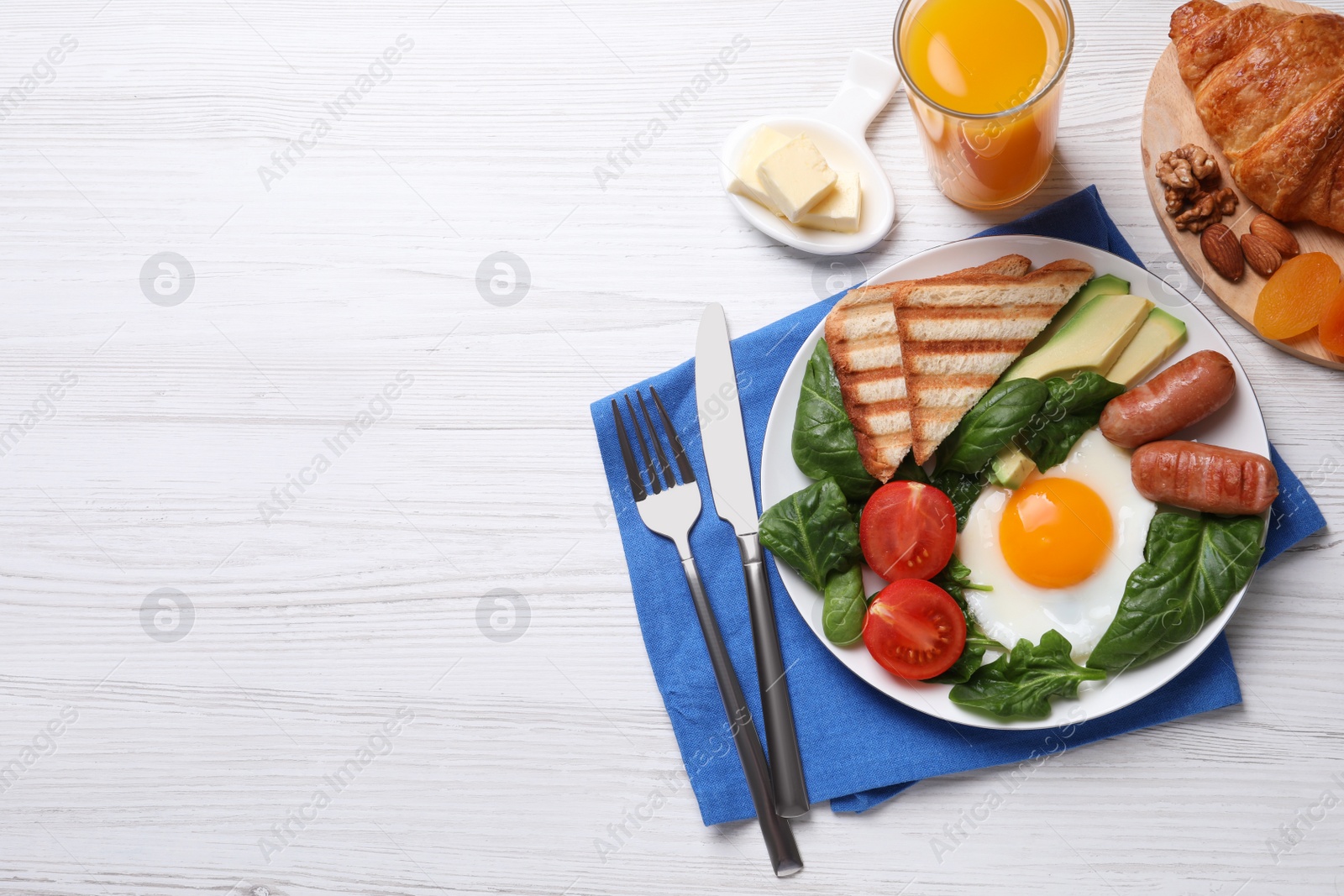 Photo of Delicious breakfast with fried egg served on white wooden table, flat lay. Space for text